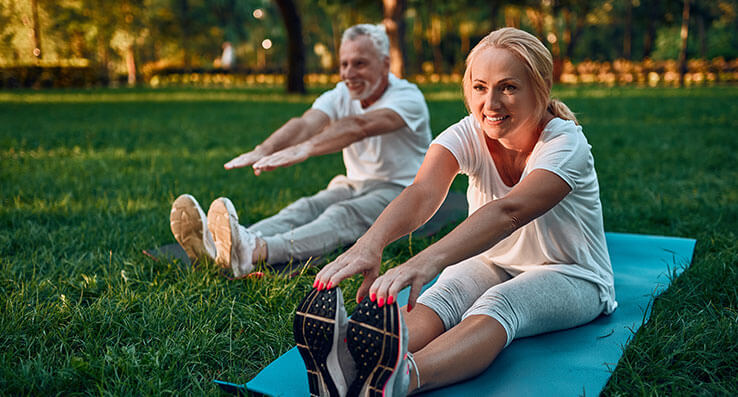 Couple stretching on yoga matts