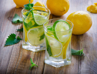 Lemon water with fresh lemons and mint. Selective focus